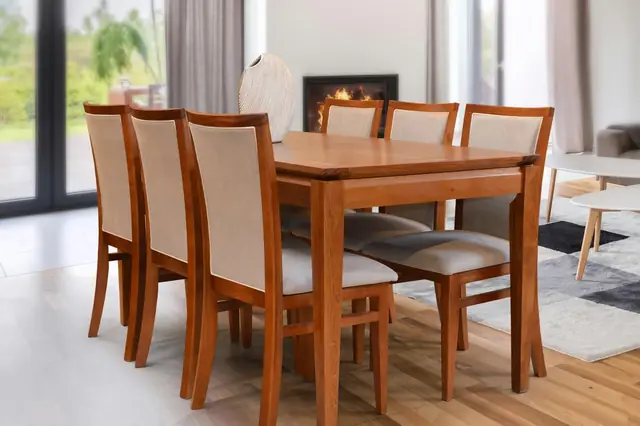 A wooden dining table with six upholstered chairs in a bright room